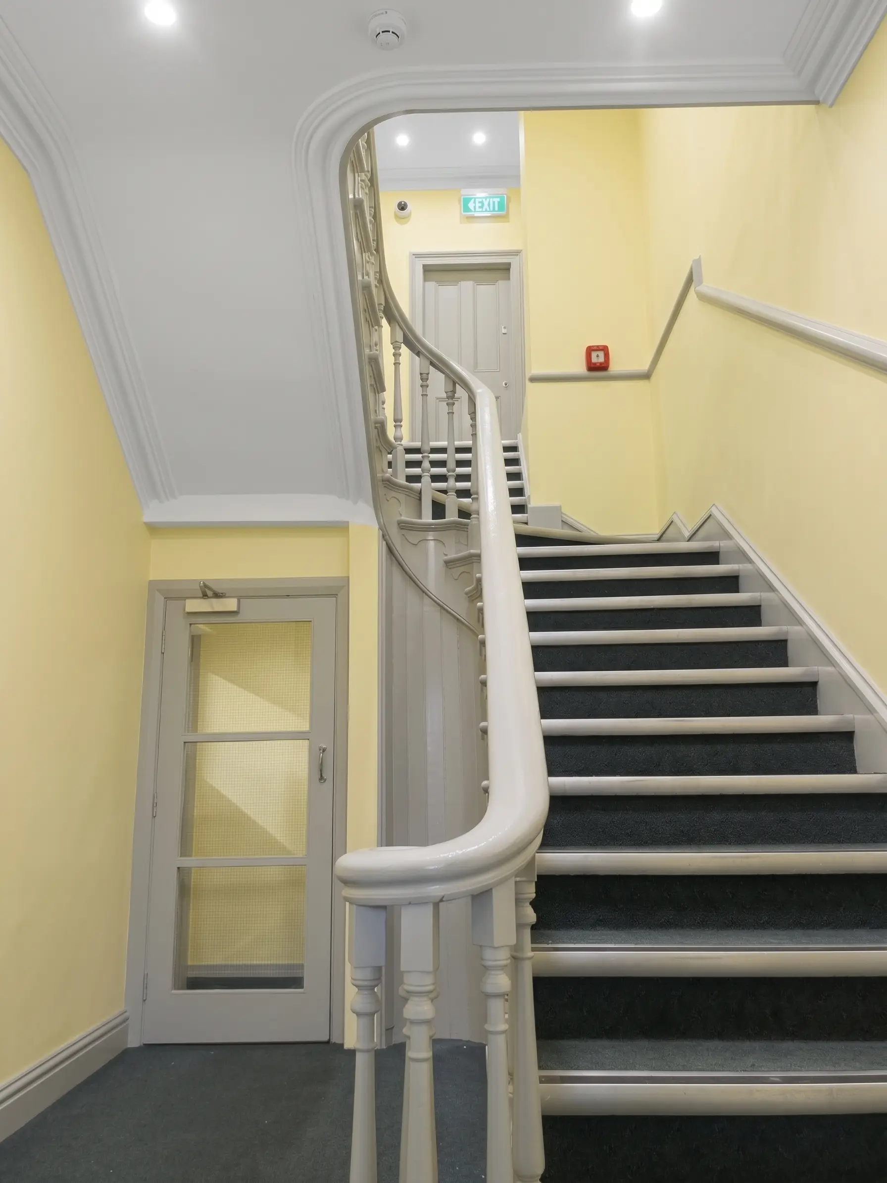 Finished stairwell painting with restored joinery and clean wall finish